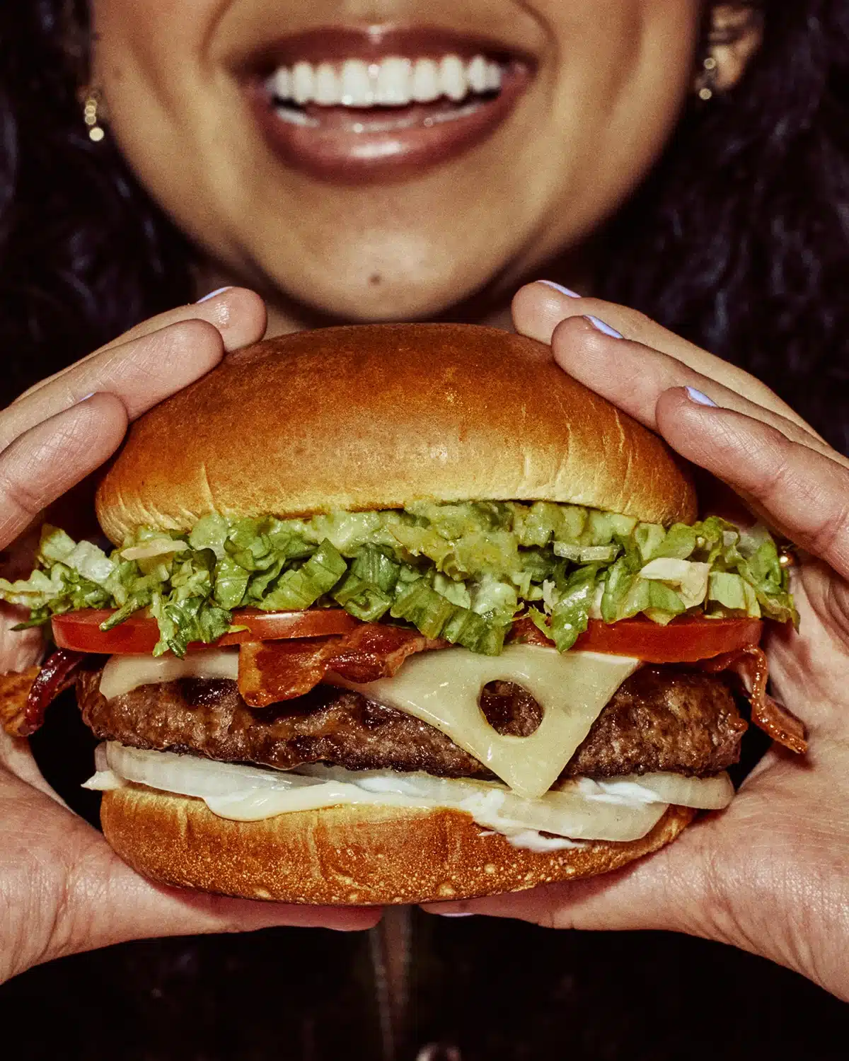 Cook presenting a burger