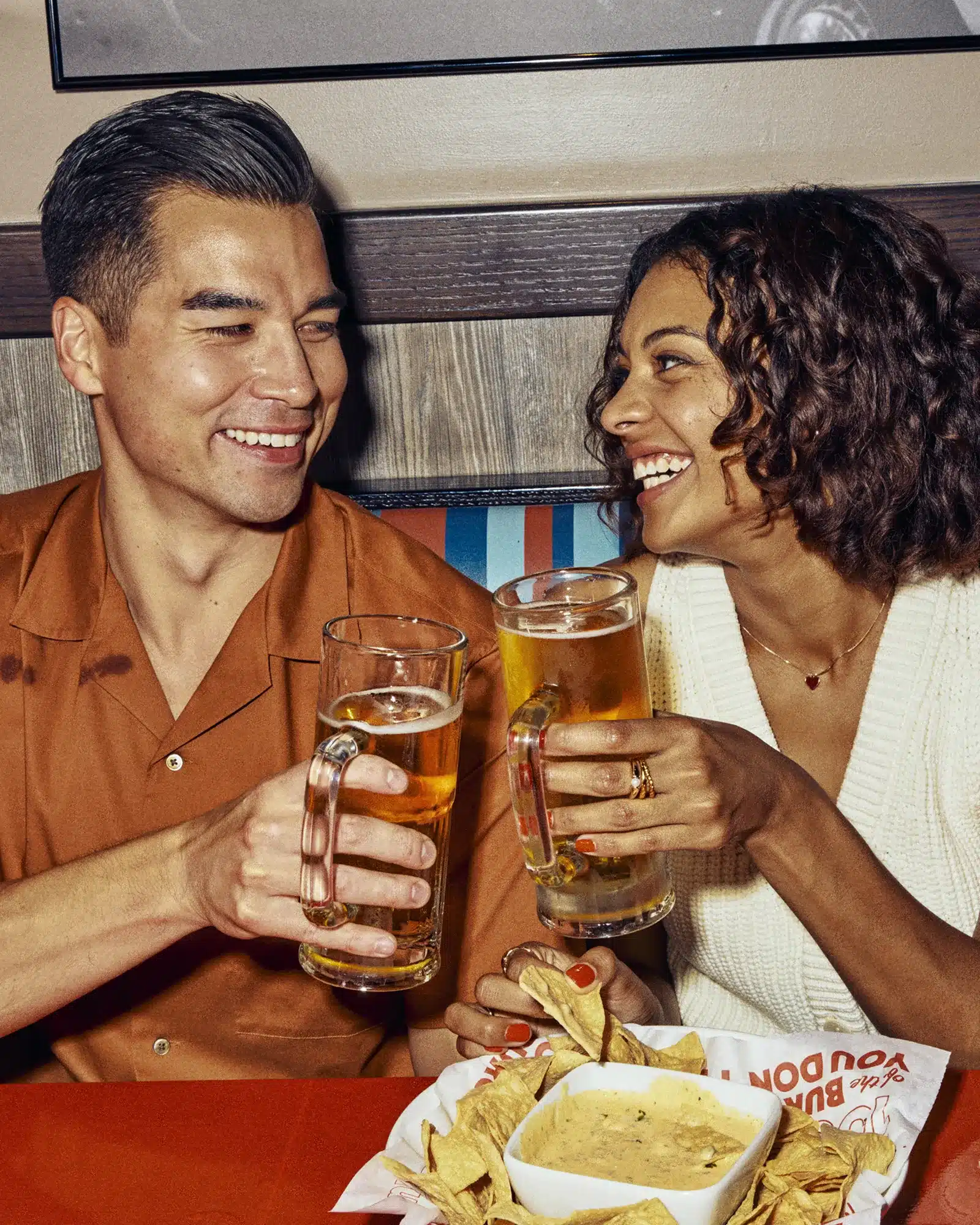 Guests toasting in a booth